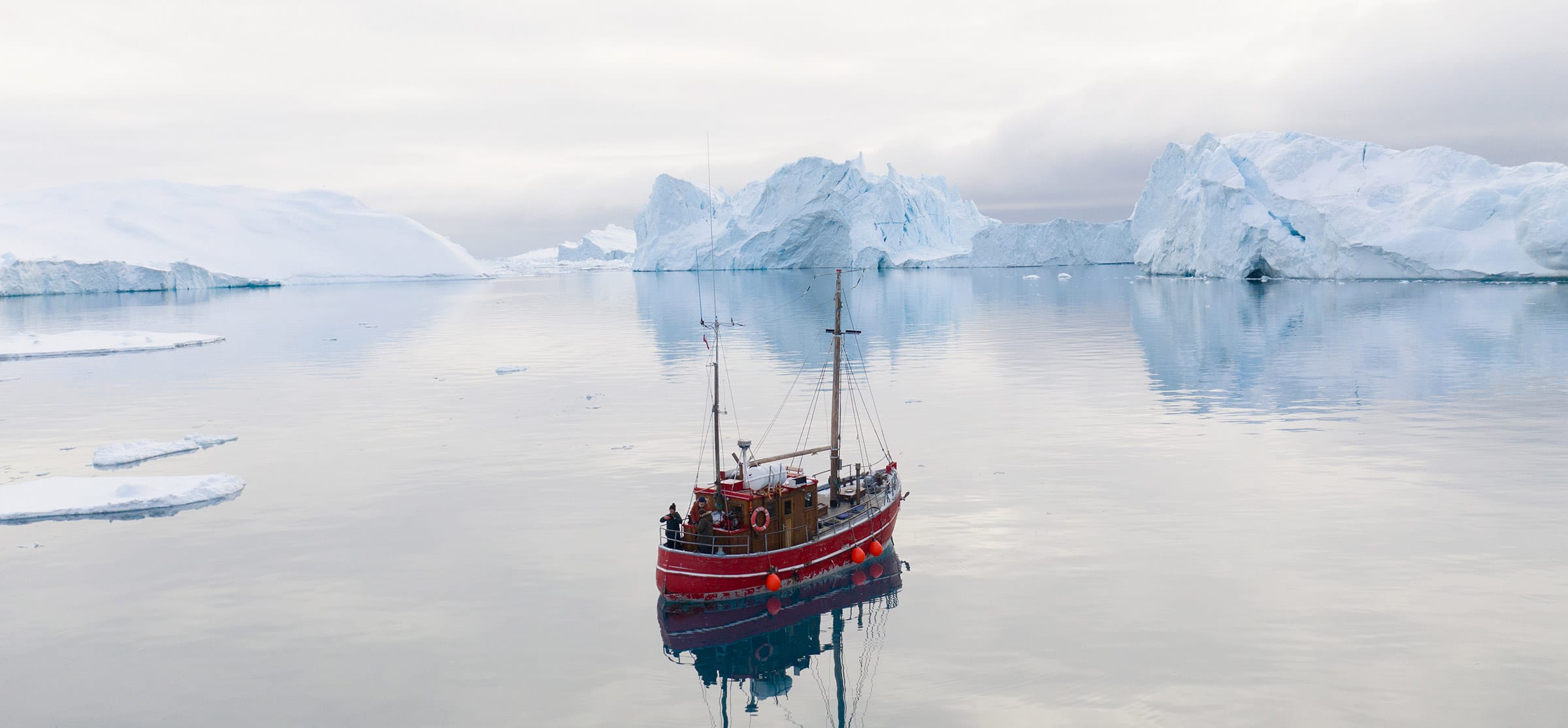 Ship Drifting Among Icebergs Near Ilulissat